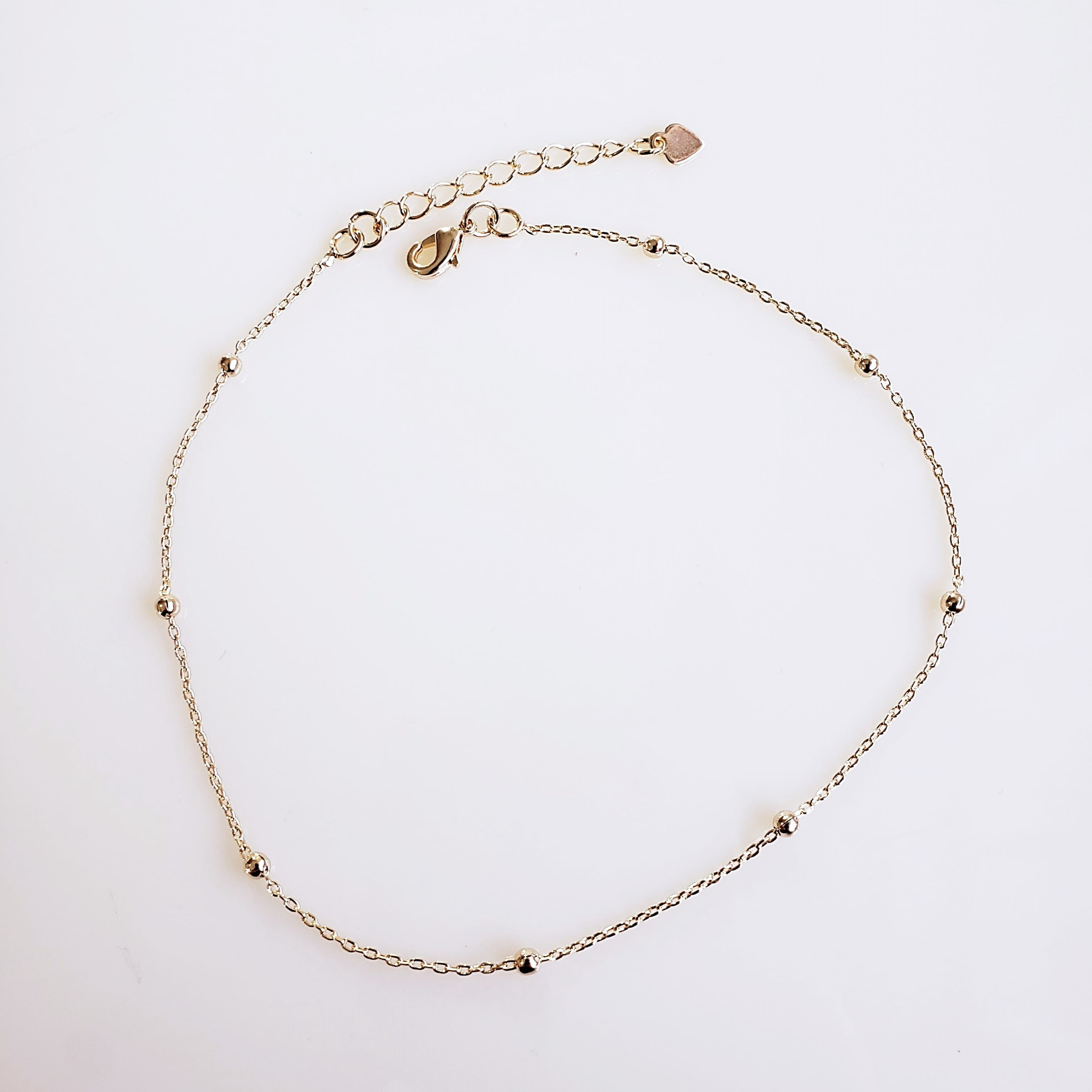 Tornozeleira com bolinhas dourada - banhado a ouro
